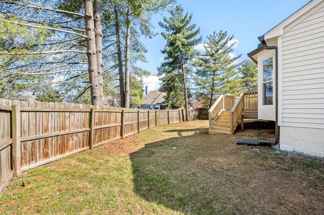 a view of a park with iron fence