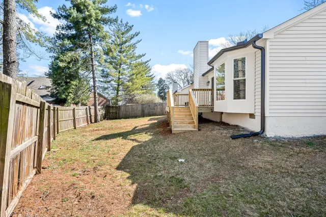 a view of a grey house with a yard
