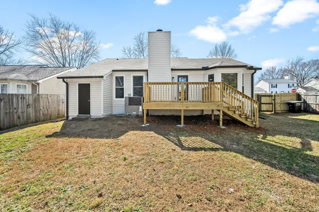 a front view of a house with a yard and seating space