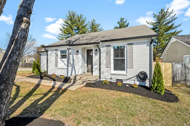 a front view of a house with sitting area
