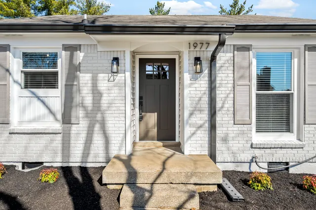a front view of a house with outdoor seating