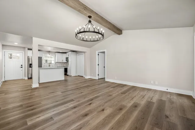 a view of a room with wooden floor