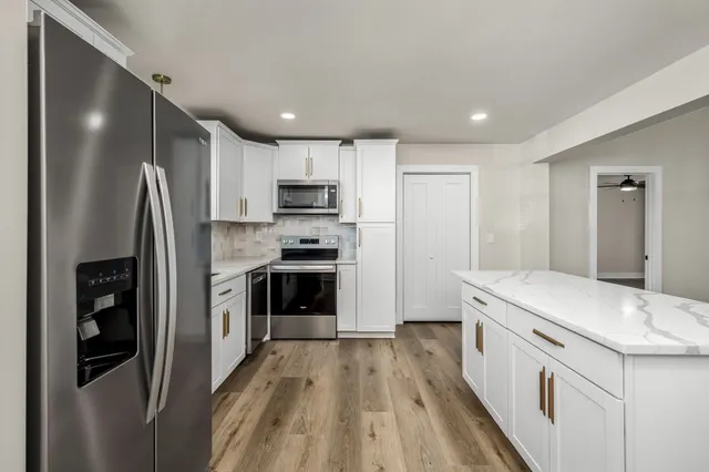 a kitchen with stainless steel appliances a refrigerator stove and sink
