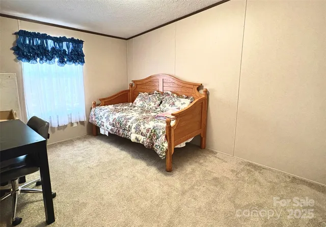 a bed sitting in a room next to a window