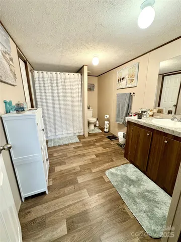 a bathroom with a sink a mirror and a toilet