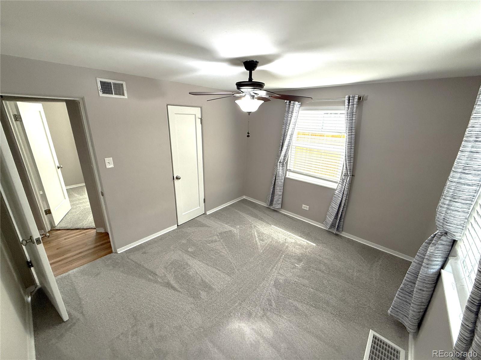 1920 Willow Street Denver, CO 80220 - Photo 12 of 41 wooden floor in an empty room with a window