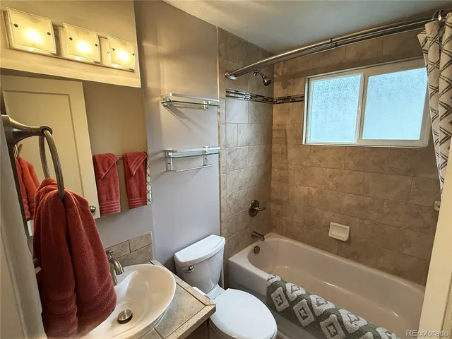 a bathroom with a toilet a sink and bathtub