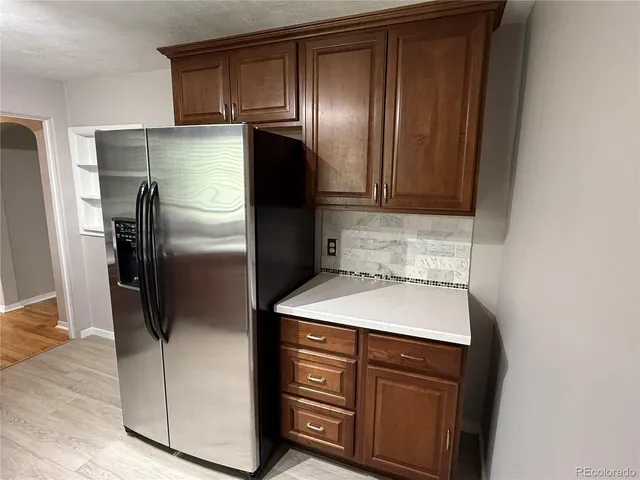 a kitchen with a refrigerator and a sink