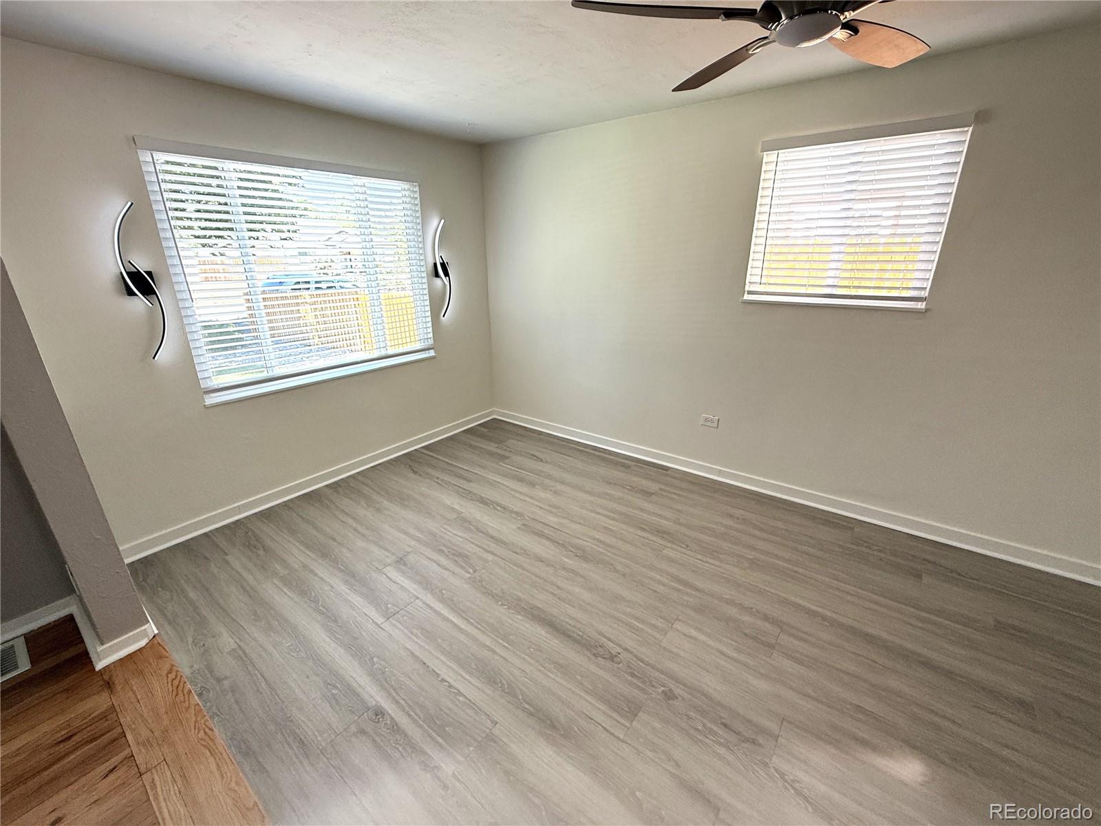 1920 Willow Street Denver, CO 80220 - Photo 26 of 41 a view of an empty room with wooden floor and a window