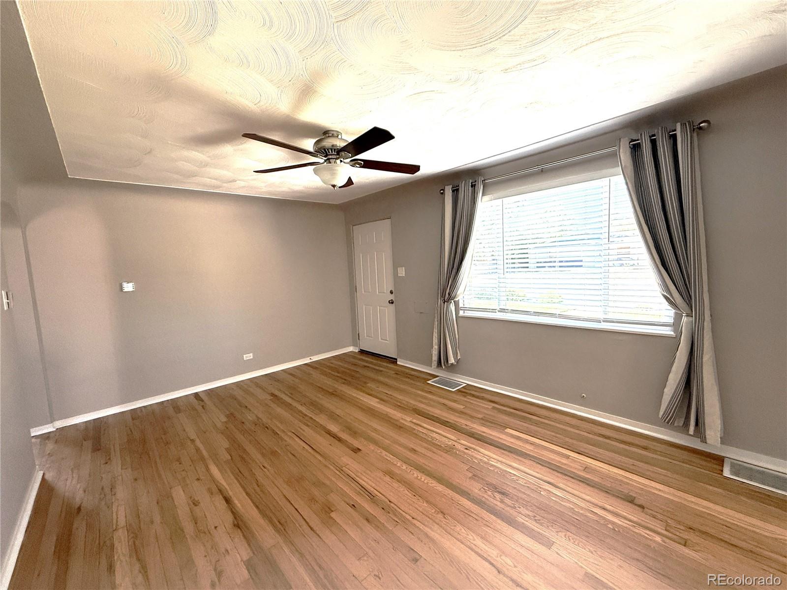 1920 Willow Street Denver, CO 80220 - Photo 28 of 41 a view of an empty room and wooden floor