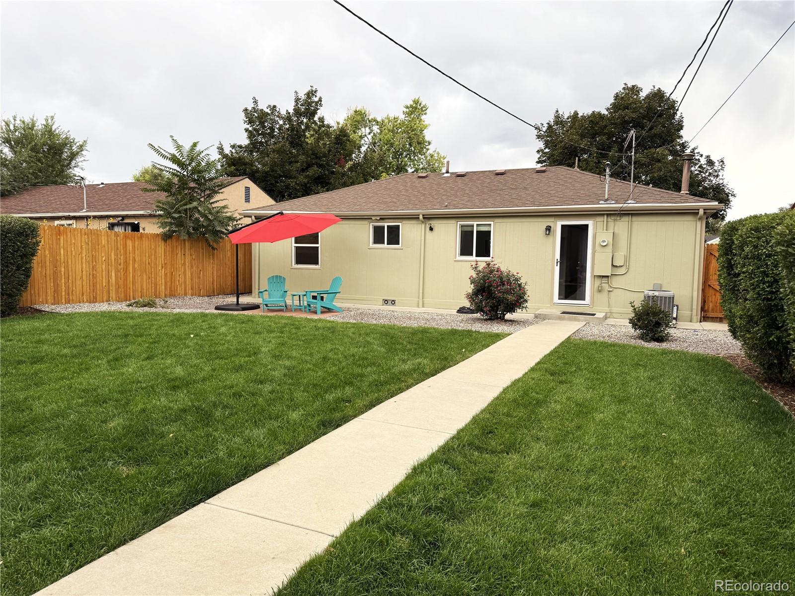 1920 Willow Street Denver, CO 80220 - Photo 35 of 41 a front view of a house with a yard and garage