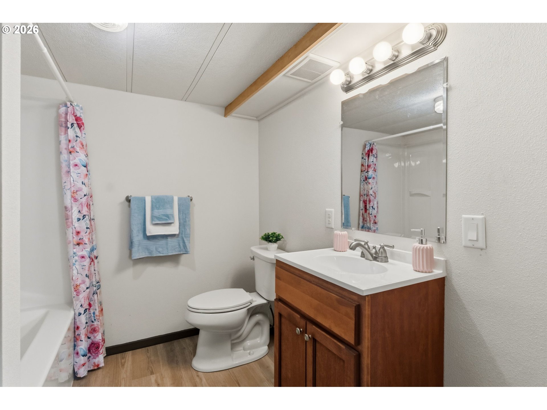 205 South 54th Street, Unit 76 Springfield, OR 97478 - Photo 15 of 41 a bathroom with a sink mirror vanity and toilet