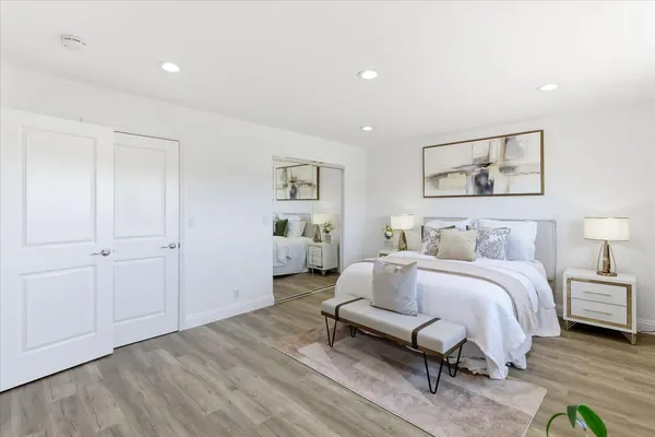 a bed sitting in a bedroom next to a window