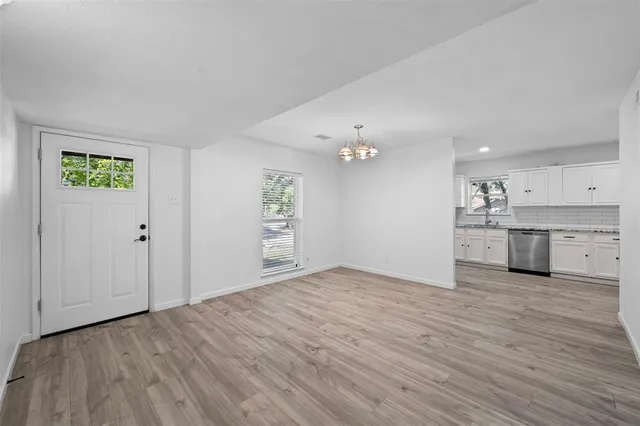 a kitchen with granite countertop a sink cabinets stainless steel appliances and a counter space