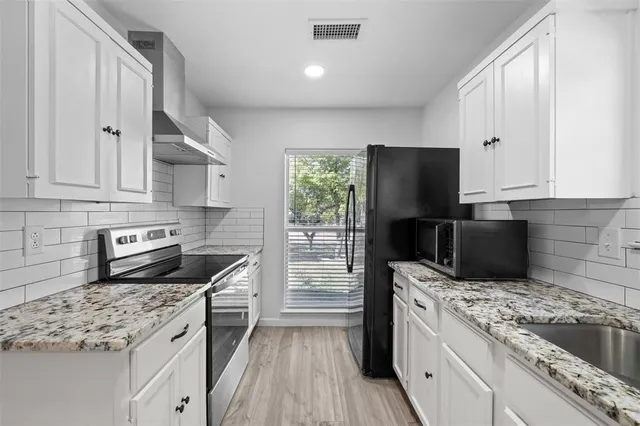 wooden floor fireplace and natural light in room