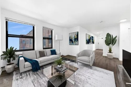 a living room with furniture a flat screen tv and a large window