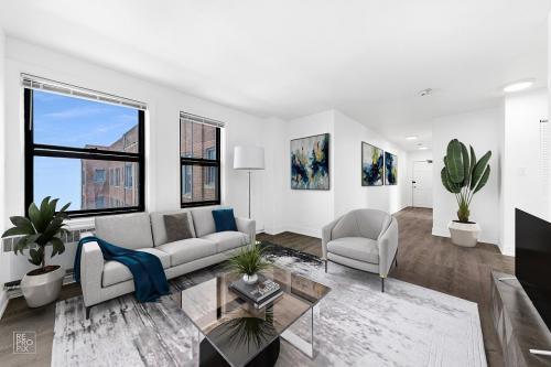 6230 North Kenmore Avenue, Unit 1107 Chicago, IL 60660 - Photo 3 of 10 a living room with furniture a flat screen tv and a large window