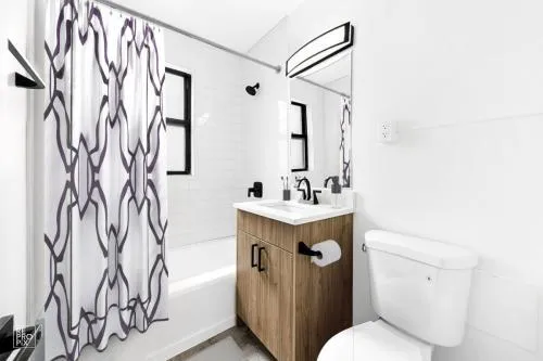 a bathroom with a sink toilet and shower