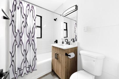 6230 North Kenmore Avenue, Unit 1107 Chicago, IL 60660 - Photo 7 of 10 a bathroom with a sink toilet and shower