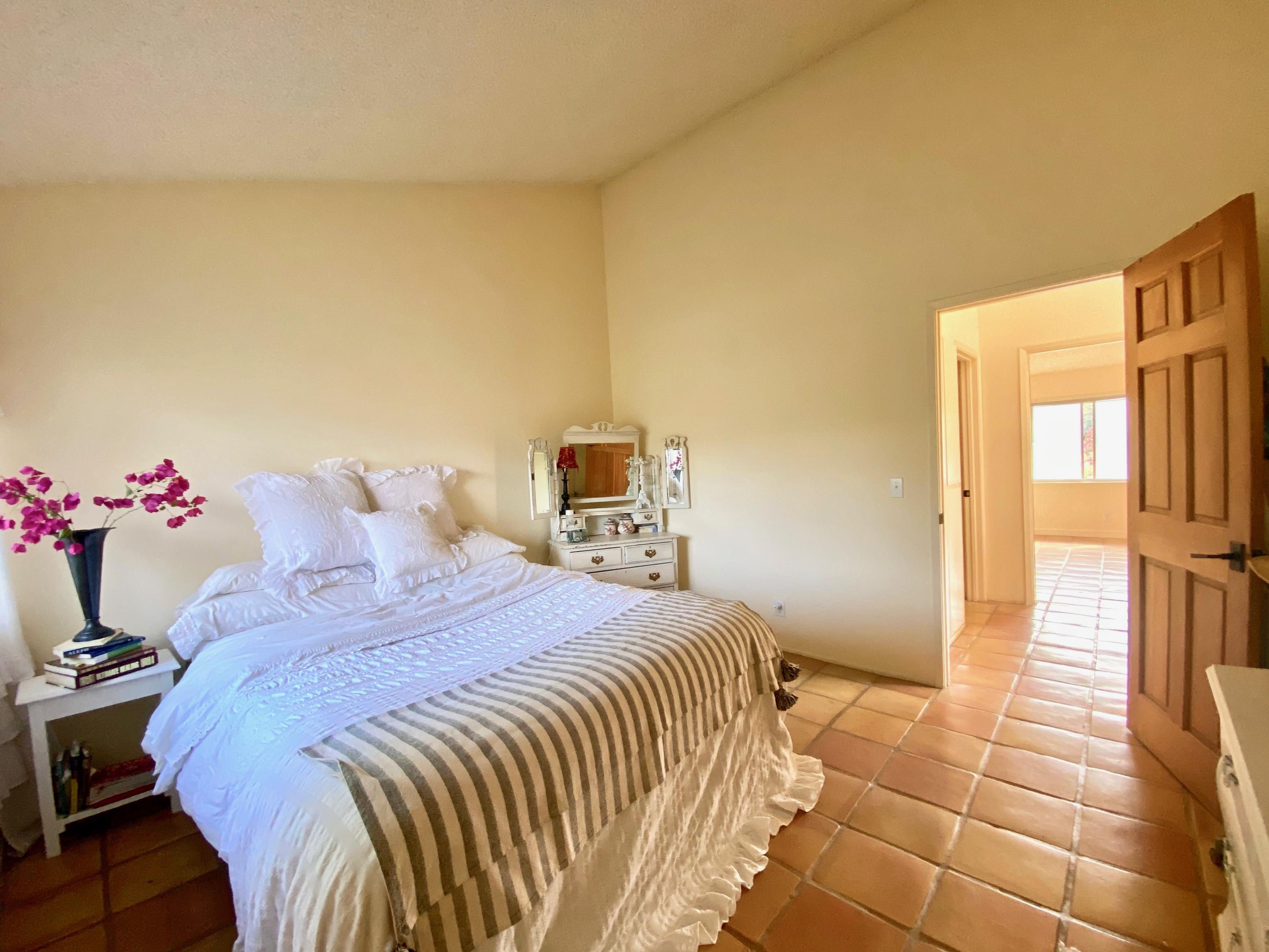 415 West Gutierrez Street, Unit 16 Santa Barbara, CA 93101 - Photo 8 of 12 a bedroom with a bed and a potted plant
