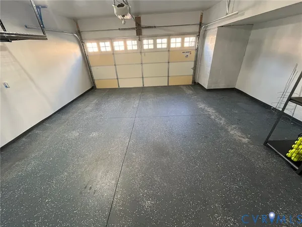 an empty room with a window and a ceiling fan