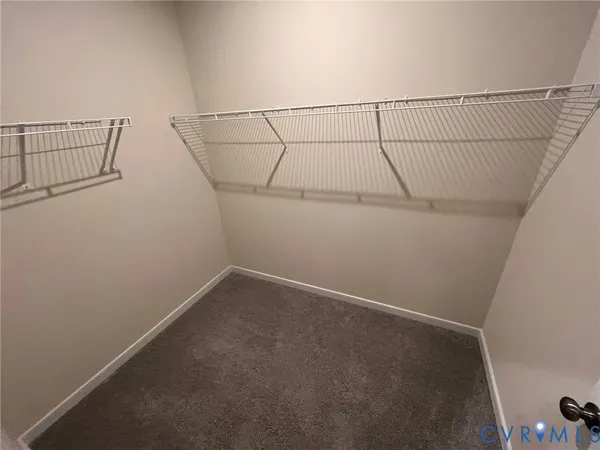 an empty room with windows and ceiling fan