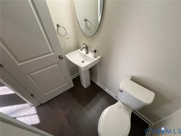a view of a kitchen with kitchen island a sink wooden floor and counter top space