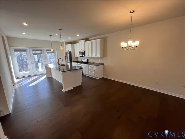 an empty room with windows and ceiling fan