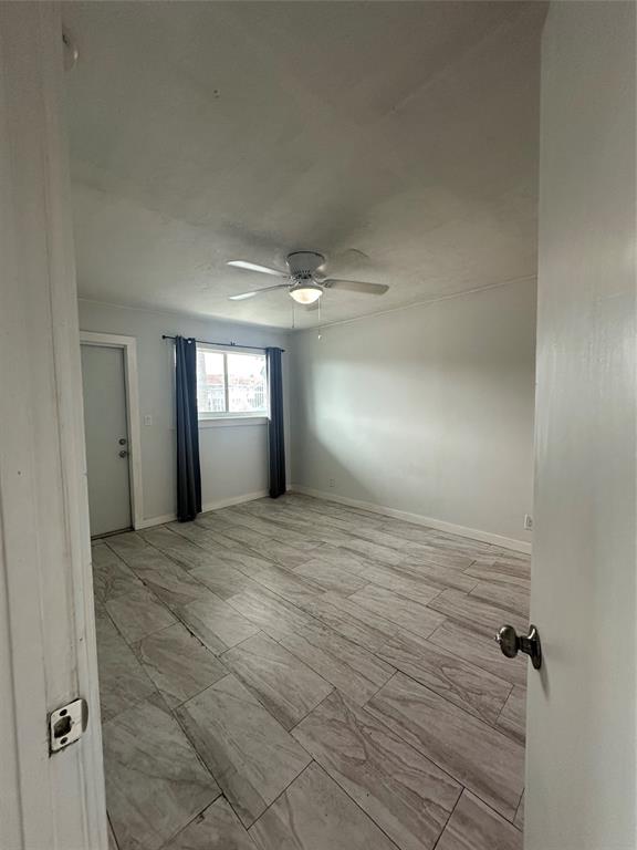 2175 Northeast 56th Street, Unit 106 Fort Lauderdale, FL 33308 - Photo 11 of 20 a view of empty room with window and fireplace