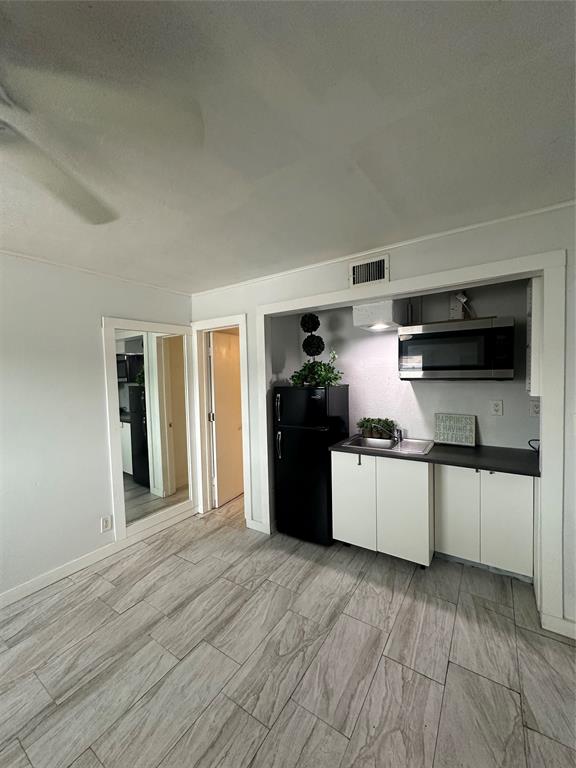 2175 Northeast 56th Street, Unit 106 Fort Lauderdale, FL 33308 - Photo 12 of 20 a kitchen with stainless steel appliances granite countertop a refrigerator and a stove top oven
