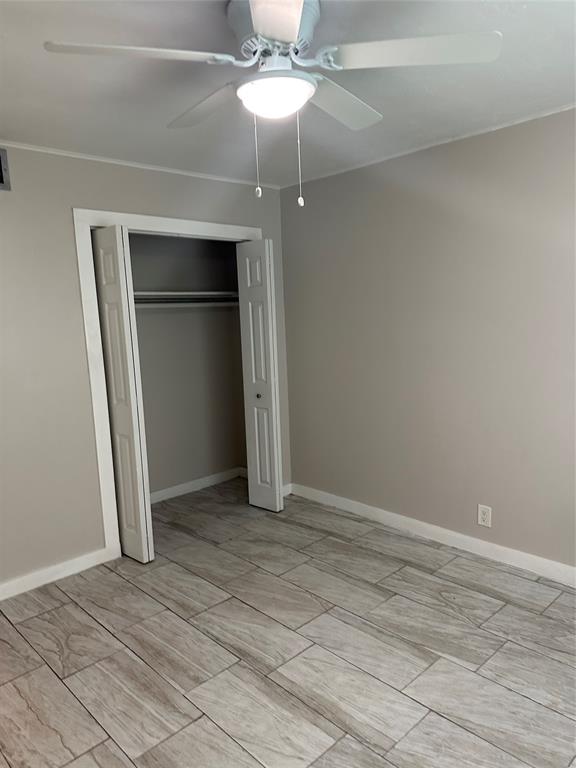 2175 Northeast 56th Street, Unit 106 Fort Lauderdale, FL 33308 - Photo 15 of 20 an empty room with a fireplace and chandelier fan