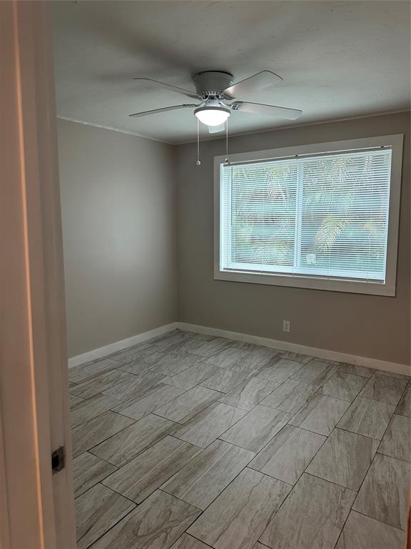2175 Northeast 56th Street, Unit 106 Fort Lauderdale, FL 33308 - Photo 16 of 20 a view of an empty room with a window