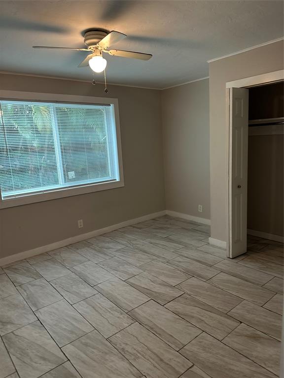 2175 Northeast 56th Street, Unit 106 Fort Lauderdale, FL 33308 - Photo 17 of 20 a view of empty room with wooden floor and fan