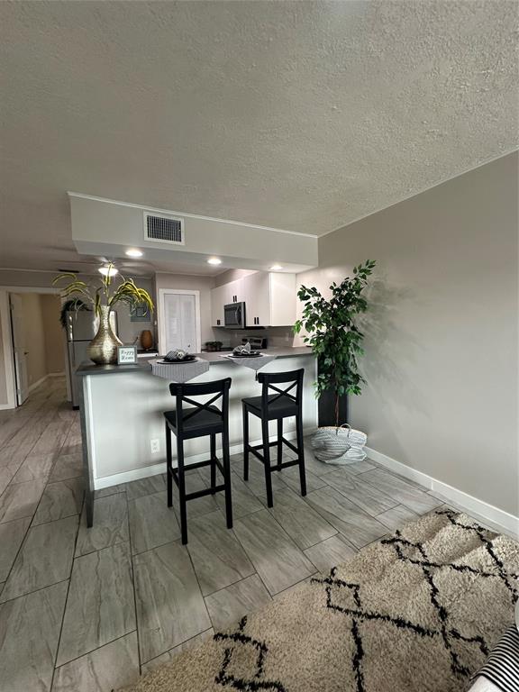 2175 Northeast 56th Street, Unit 106 Fort Lauderdale, FL 33308 - Photo 3 of 20 a view of a dining room with furniture