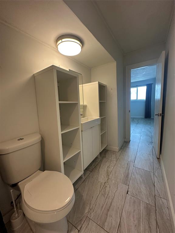 2175 Northeast 56th Street, Unit 106 Fort Lauderdale, FL 33308 - Photo 8 of 20 a bathroom with a toilet and a sink