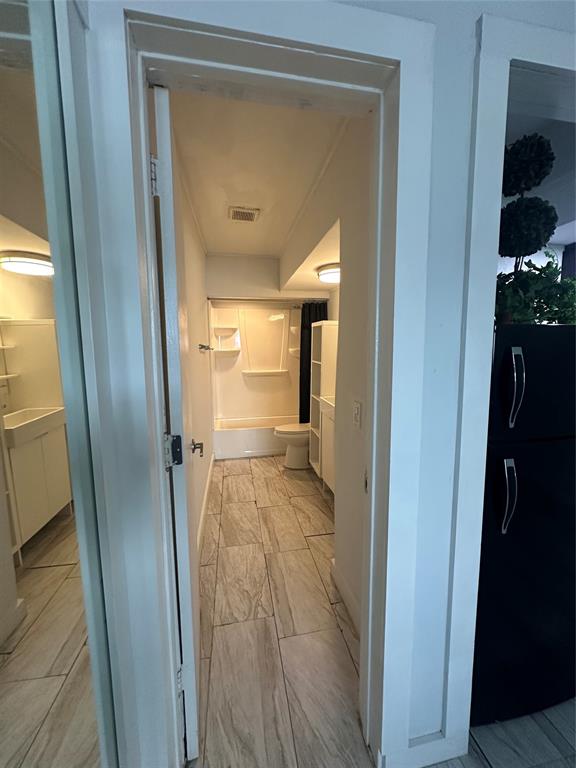 2175 Northeast 56th Street, Unit 106 Fort Lauderdale, FL 33308 - Photo 9 of 20 a view of a bathroom from a hallway