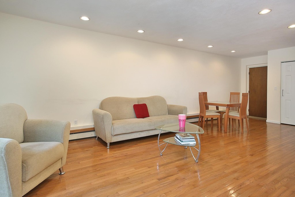383 Langley Road, Unit 6 Newton, MA 02459 - Photo 3 of 6 a living room with furniture and kitchen view