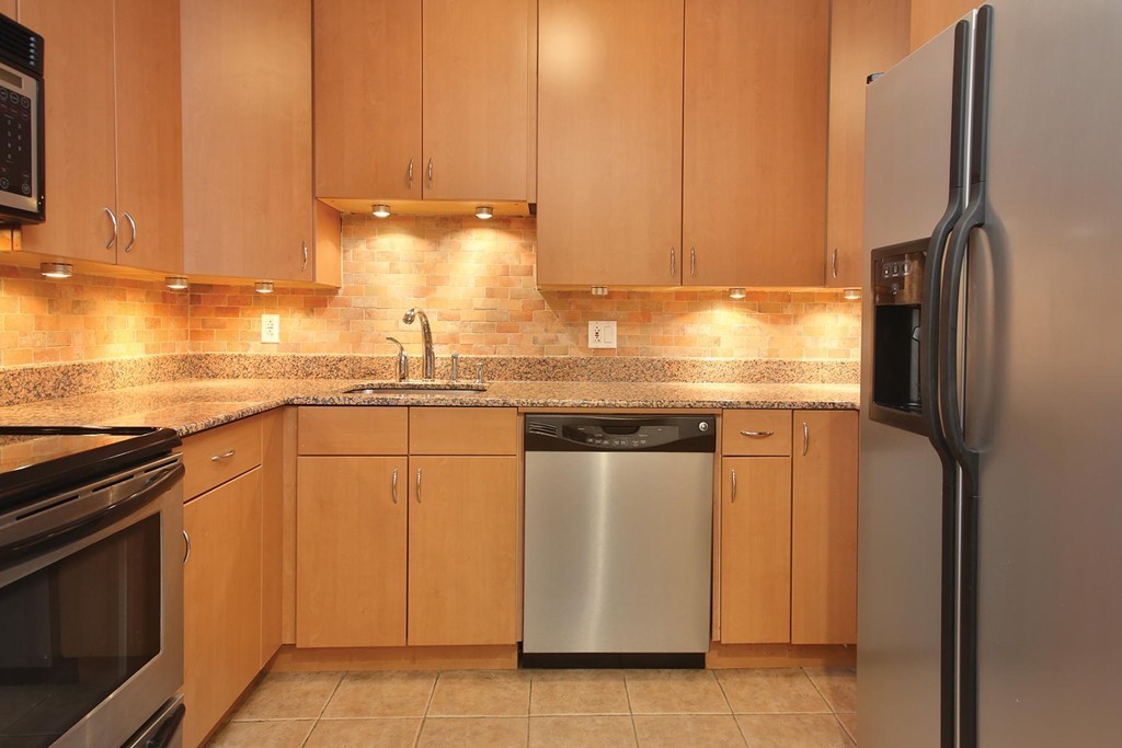 383 Langley Road, Unit 6 Newton, MA 02459 - Photo 4 of 6 a kitchen with stainless steel appliances granite countertop a refrigerator a stove and a sink