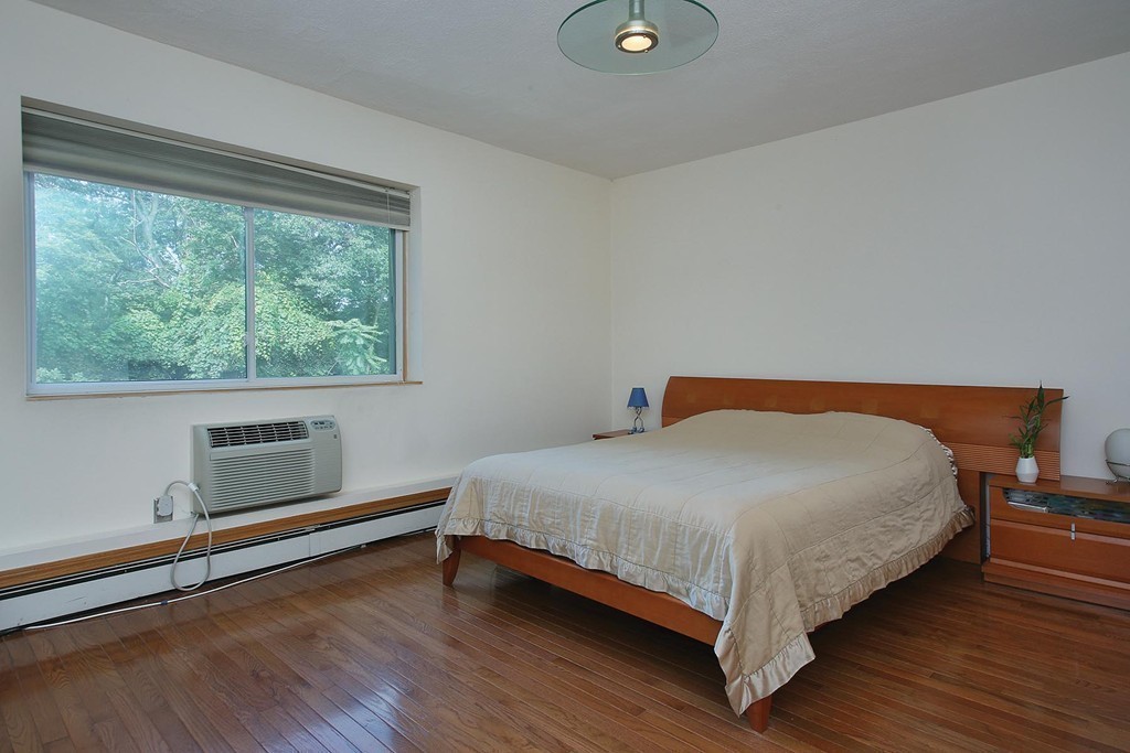 383 Langley Road, Unit 6 Newton, MA 02459 - Photo 5 of 6 a bedroom with a bed and a window