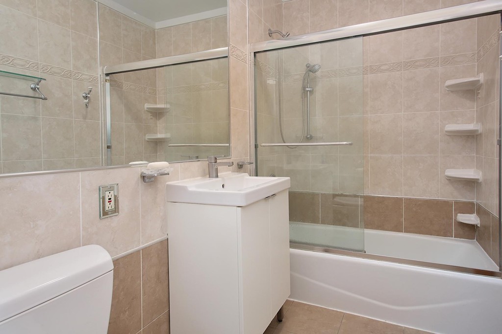 383 Langley Road, Unit 6 Newton, MA 02459 - Photo 6 of 6 a bathroom with a sink a toilet and shower