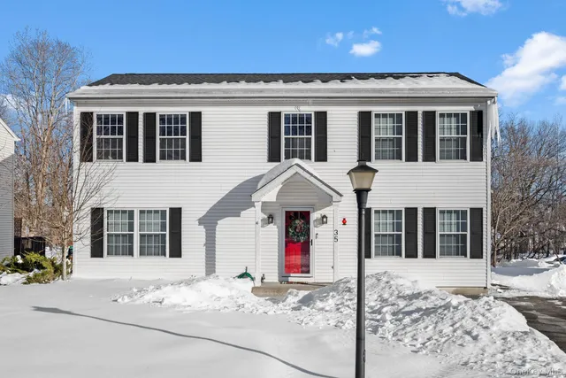 a view of a white house with a large windows