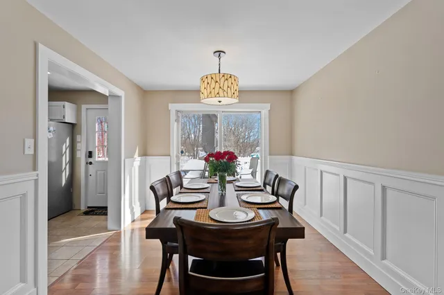 a dining room with furniture and a potted plant