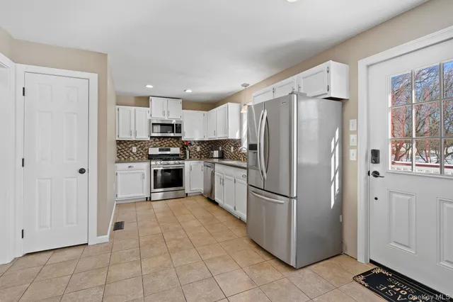a kitchen with stainless steel appliances a sink and cabinets