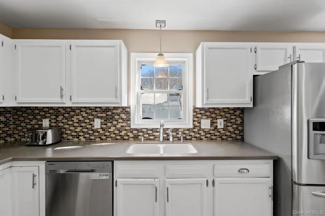 a kitchen with stainless steel appliances a refrigerator and a stove