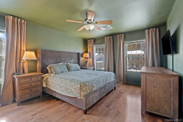 a bedroom with a large bed and a chandelier