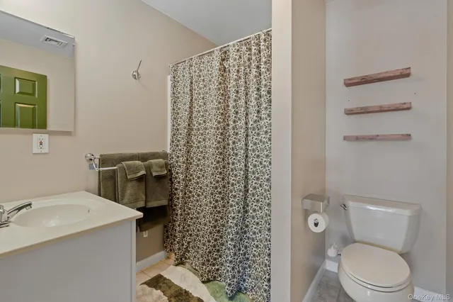 a en suite bathroom with a sink and a mirror