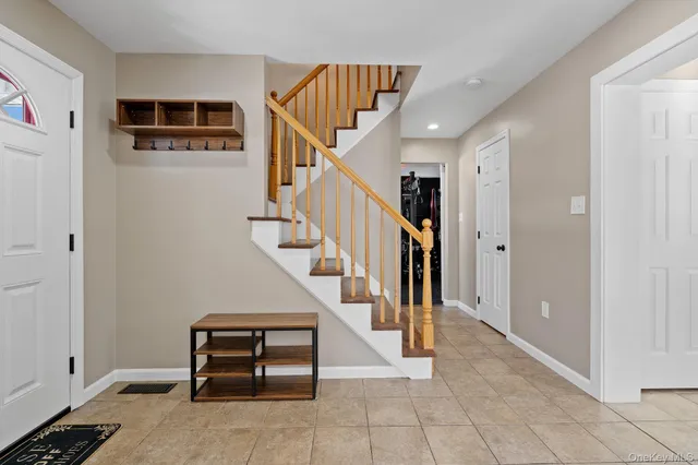 a view of an entryway with workspace and stairs