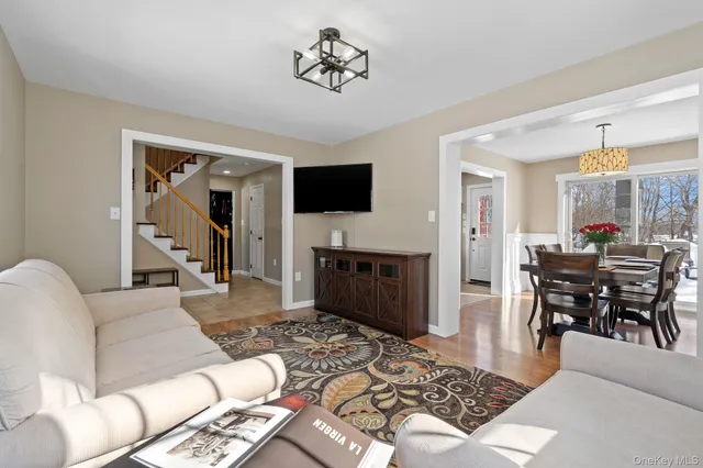 a view of a dining room with furniture wooden floor and a chandelier
