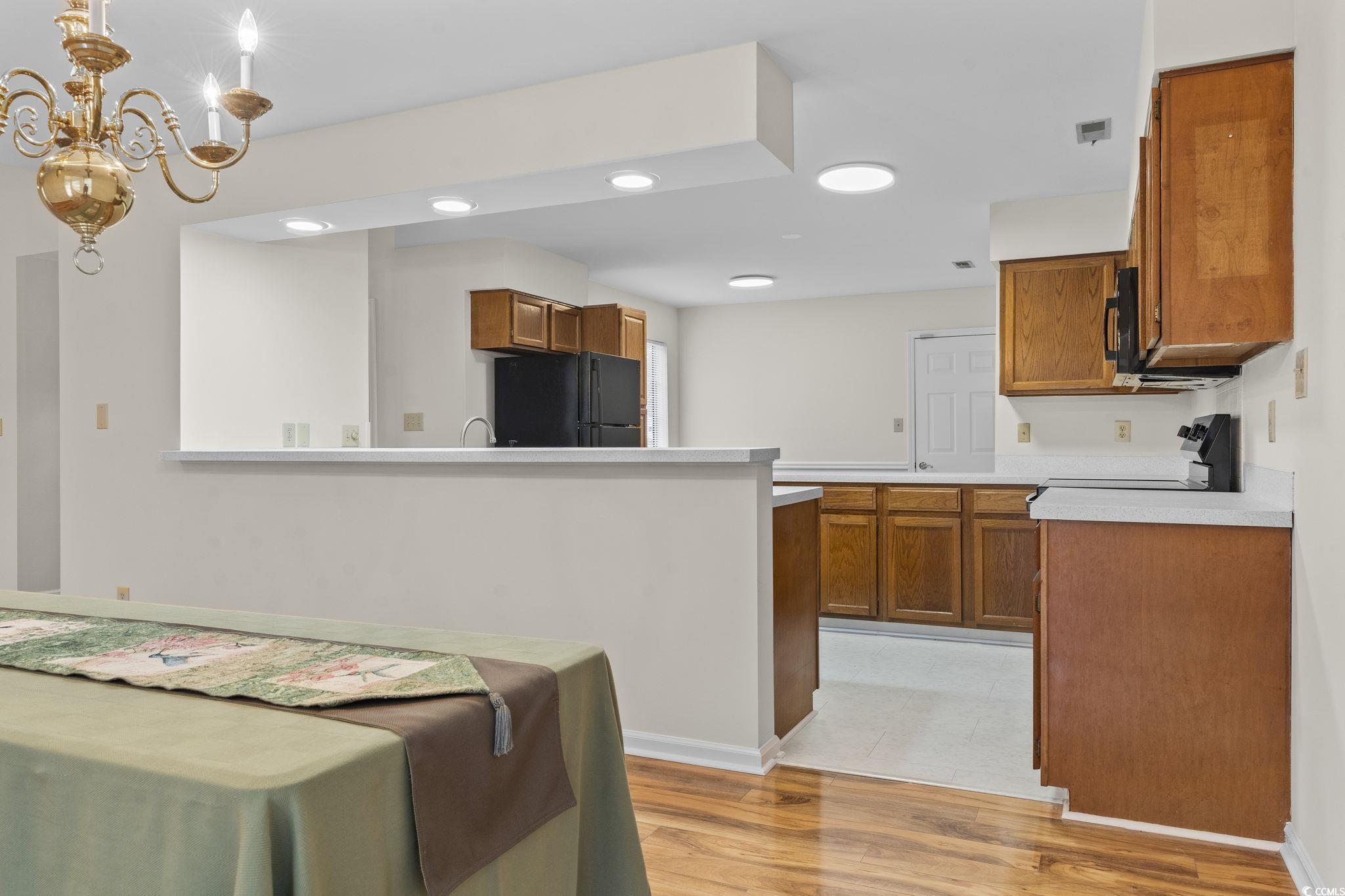 116 Purple Martin Drive Murrells Inlet, SC 29576 - Photo 20 of 40 Kitchen with an inviting chandelier, black refrige
