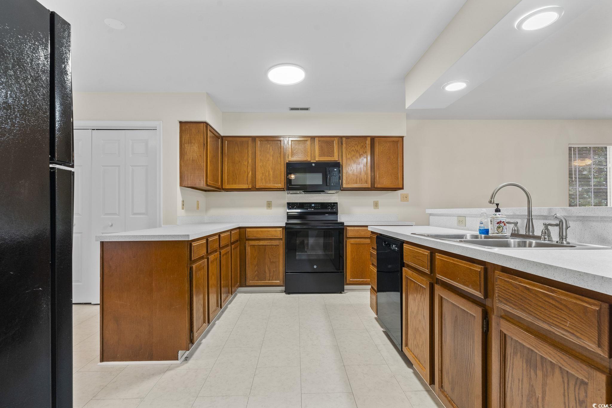116 Purple Martin Drive Murrells Inlet, SC 29576 - Photo 27 of 40 Kitchen featuring black appliances and sink